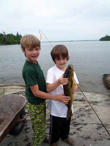 Fishing provides a perpetual series of occasions for hope. And, for some, like my son pictured here on the right, it is the sport of drowning worms. He caught 10 pickerel today, the largest being over 3lbs.